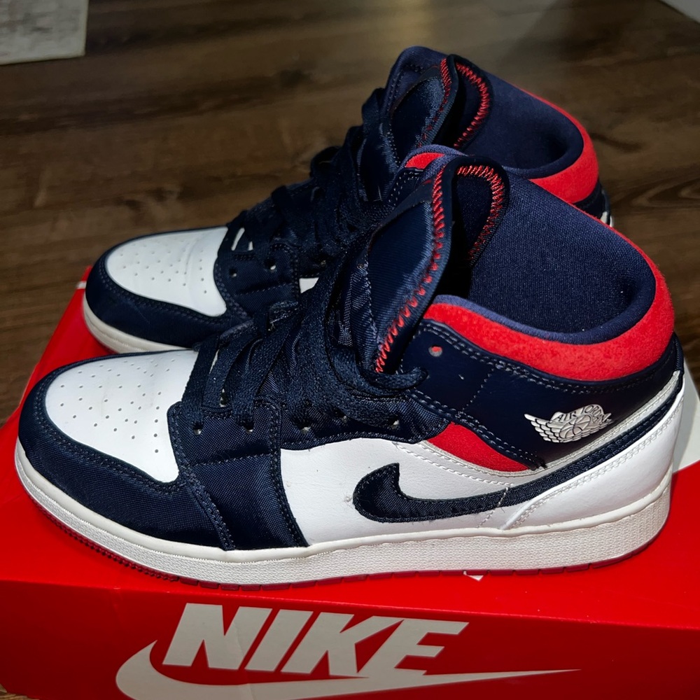 Jordan’s Navy & White High-Top Sneakers with Red Accents